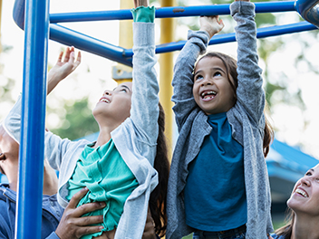 two preschool girls climbing on jungle gym