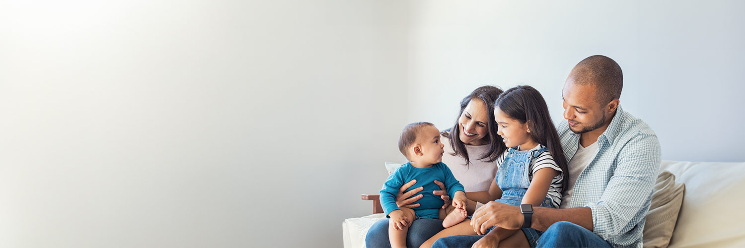 A family sitting on a couch.