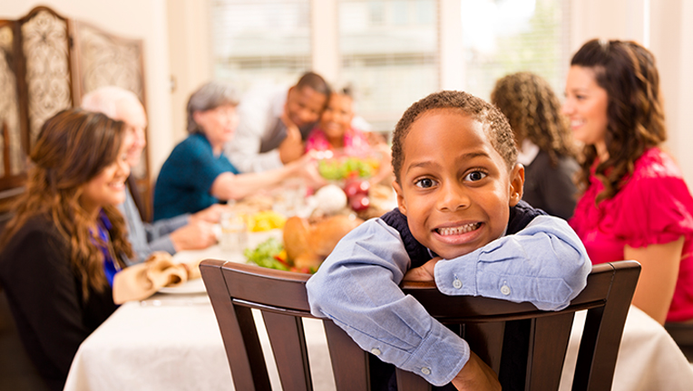 Boy smiling at family holiday dinner.