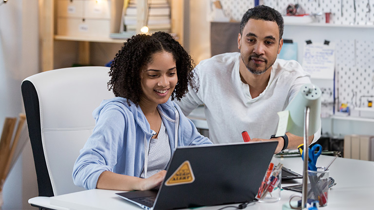 Parents Working Remotely with Child.